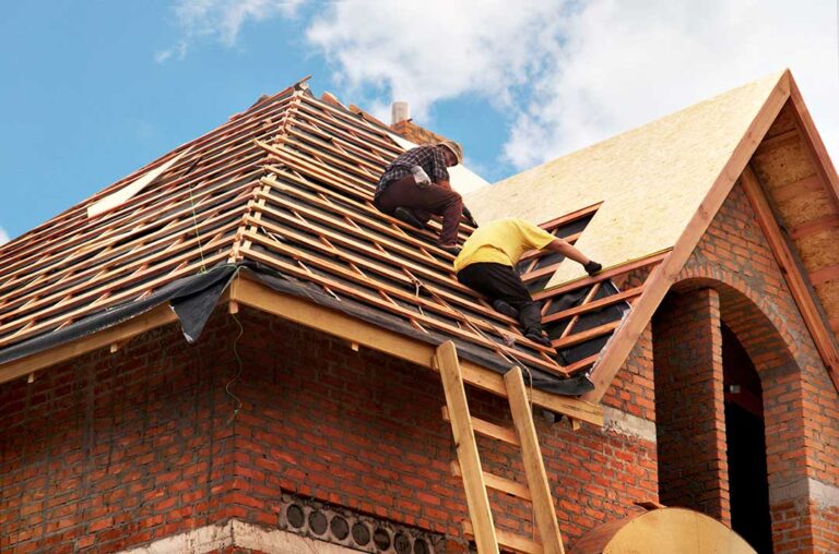 Homeowner photographs shingles and an indoor ceiling stain while organizing receipts and damage notes.